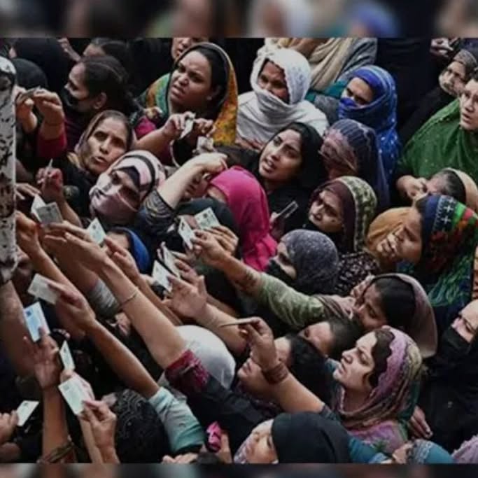 People holding up their ID cards in the ration distribution queue