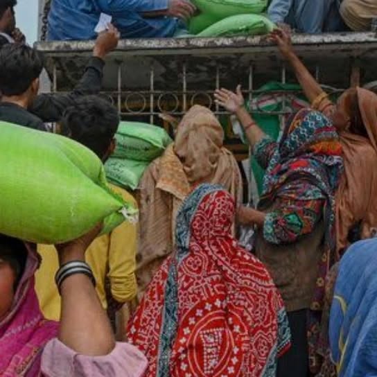 Our volunteers unloading flour bags from a truck at a ration distribution