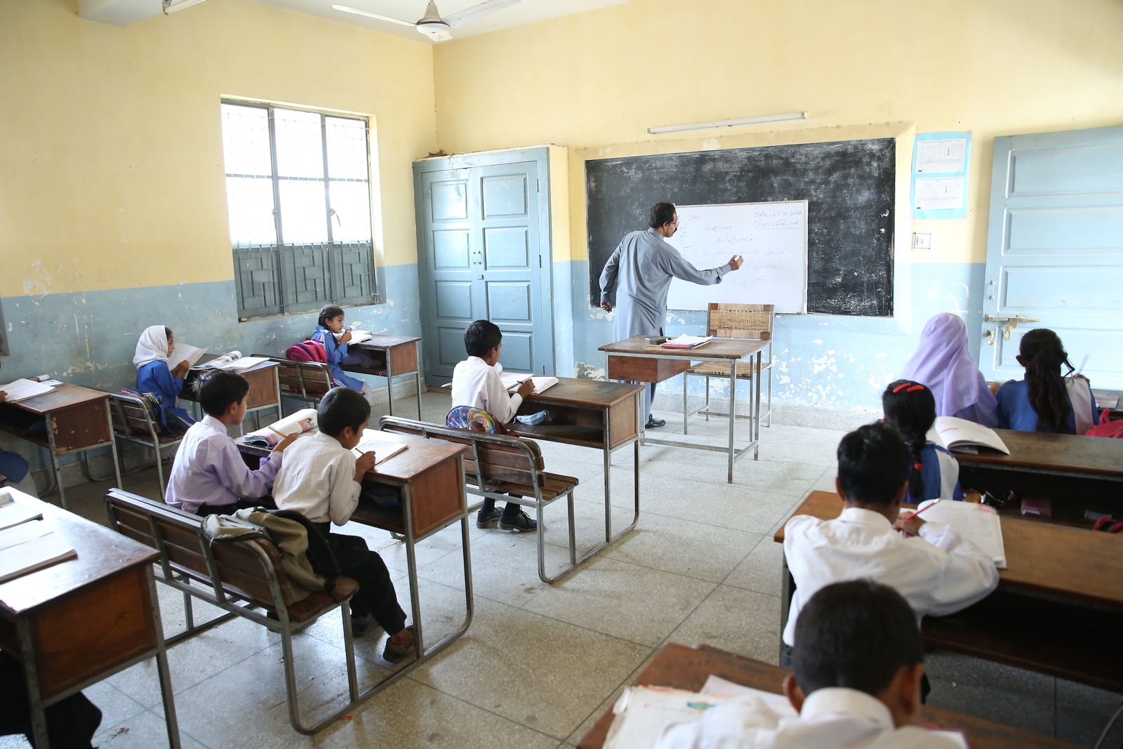 Children studying together in a modest classroom