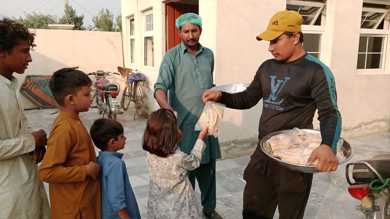 Volunteers preparing food ration bags for distribution to needy families