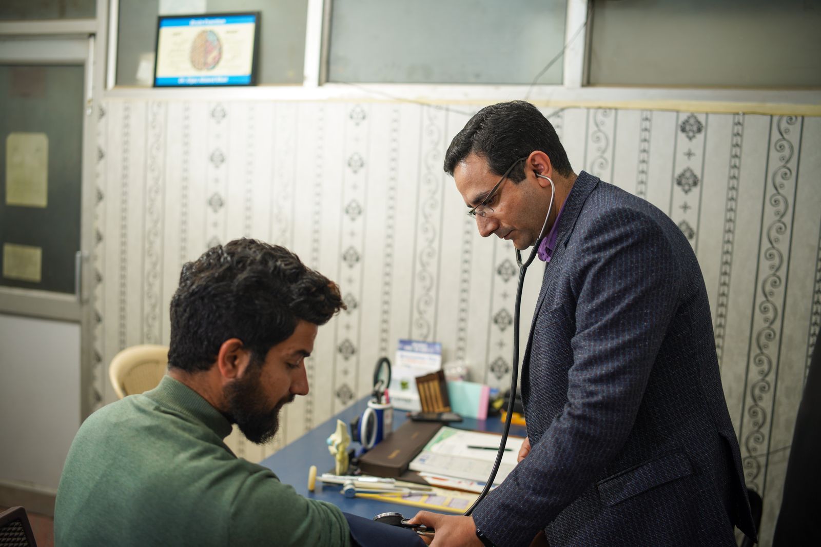 Health worker checking a patient's blood pressure at a community clinic